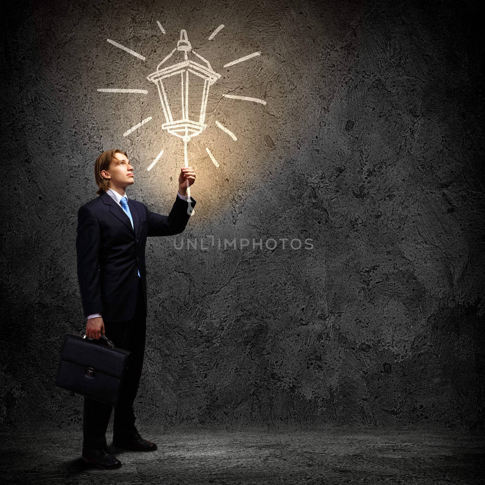 Image of businessman in black suit against dark background