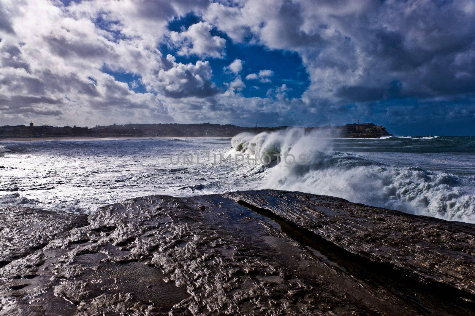 Wave rolling on to the rocky seashore in Yorkshire, England