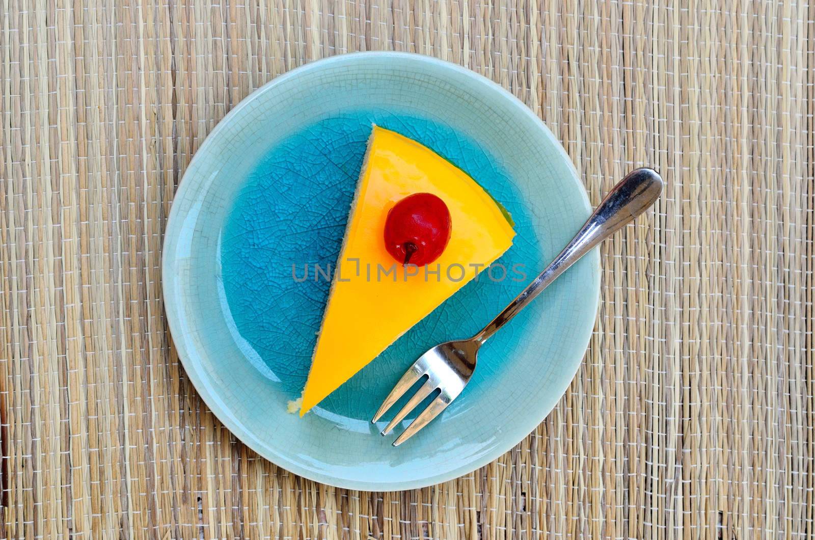 Orange cake in blue dish, Top view