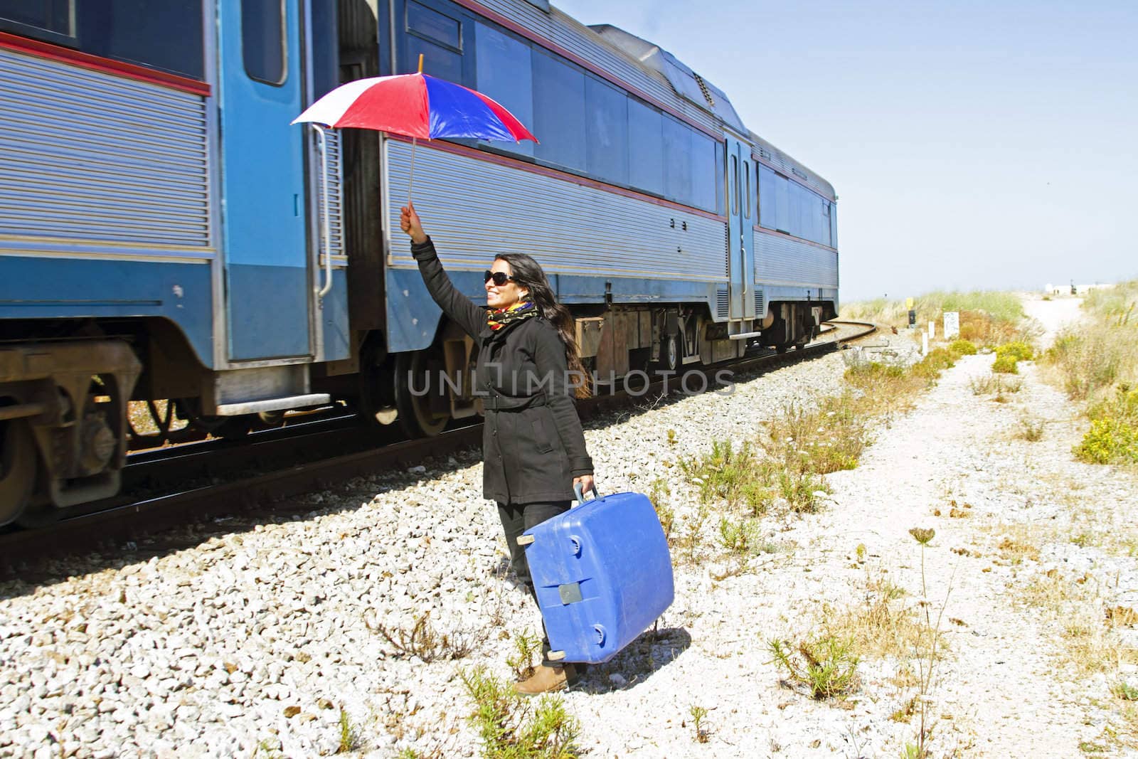 Woman traveler at a passing train by devy