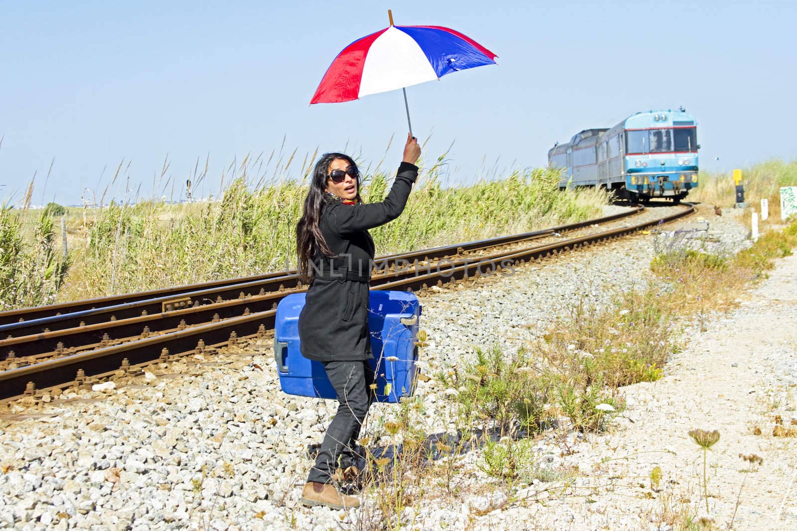Young desperate woman at a passing train