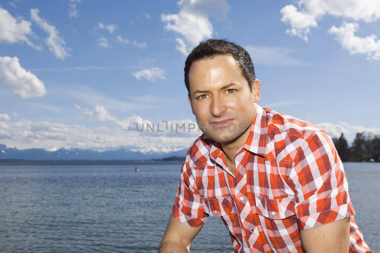 An image of a handsome man at the lake