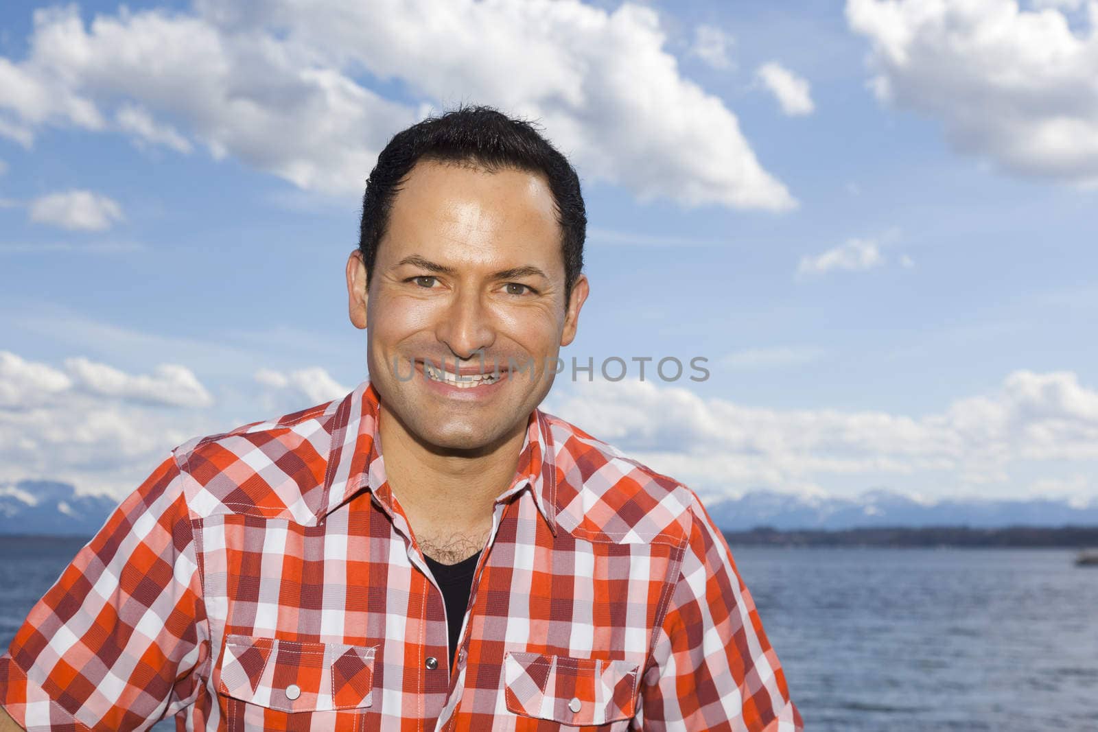 An image of a handsome man at the lake