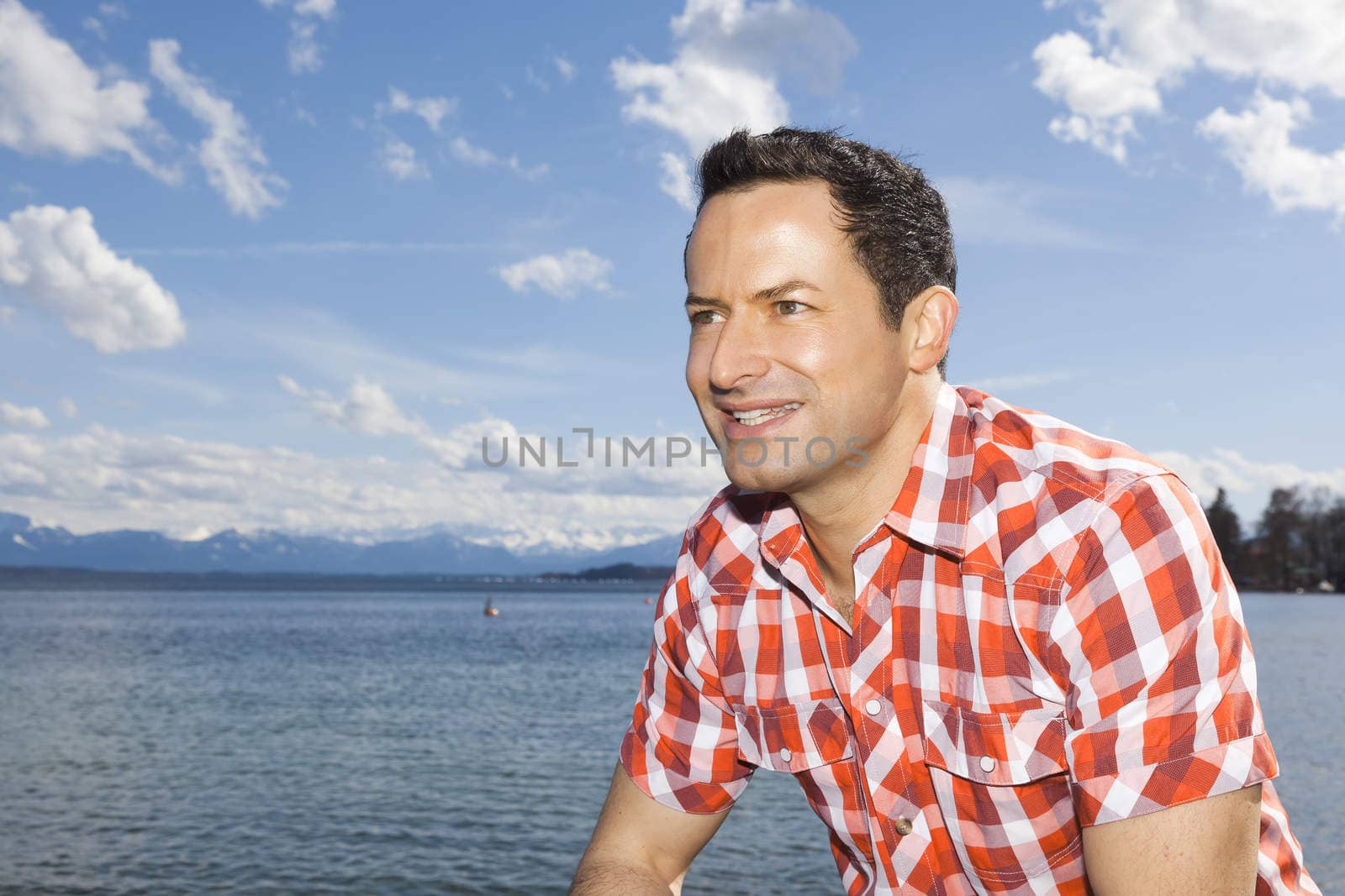 An image of a handsome man at the lake