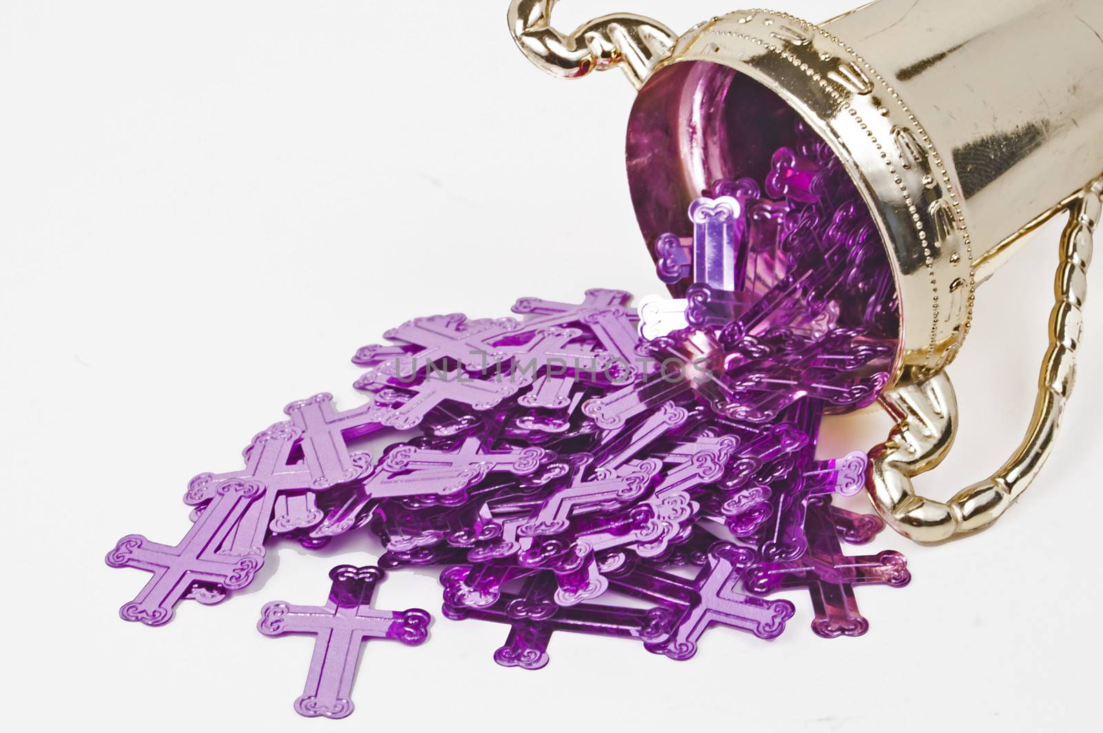 Purple crosses spill out of a gold chalice.