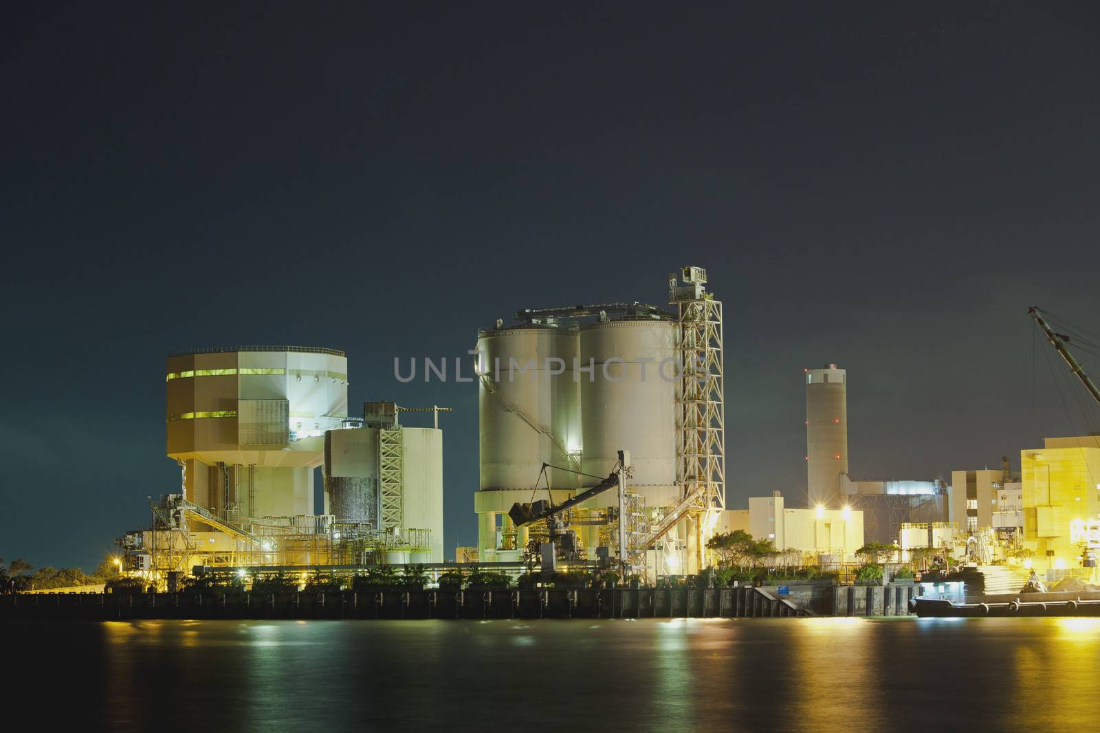 Oil tanks at night in gas factory