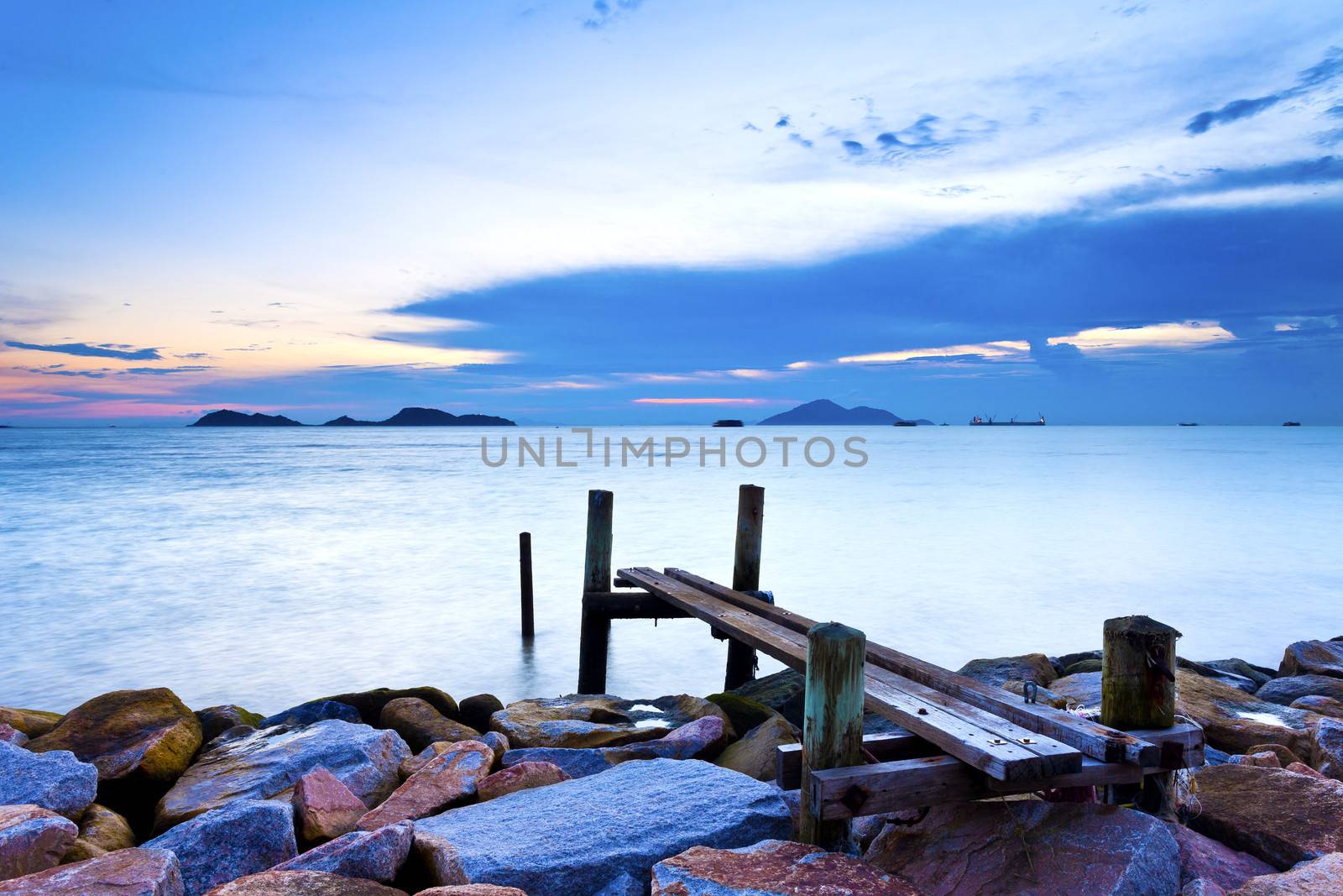 Jetty on sea at sunset by kawing921