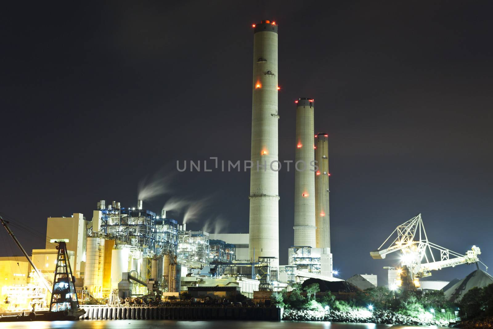 Smoking industrial power plant at night  by kawing921