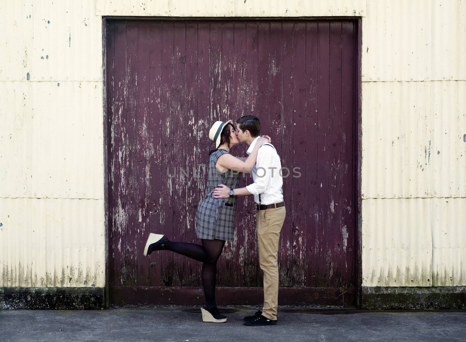 Retro hip hipster romantic love couple kissing industrial setting
