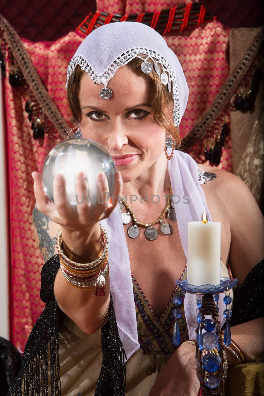 Grinning female fortune teller holding a crystal ball