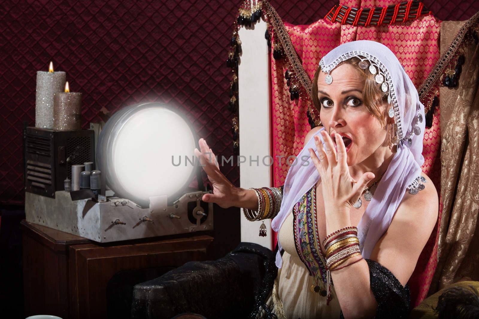 Startled sexy female fortune teller in headscarf