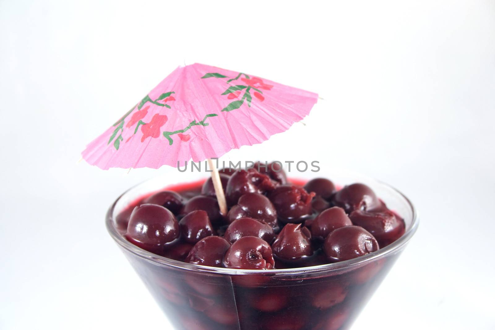 Cherry in cup decorated with umbrella