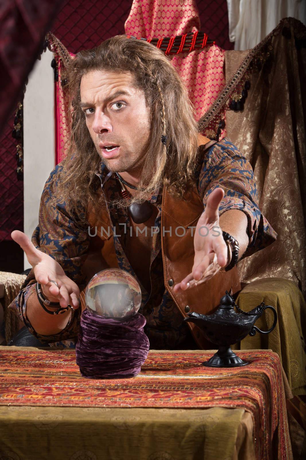Cute man with crystal ball and open hands