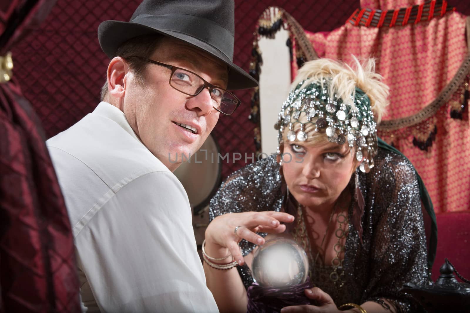 Businessman with eyeglasses with crystal ball fortune teller