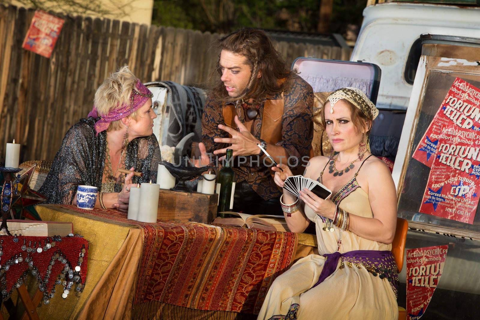 Group of gypsies outside meeting at fortune teller stand