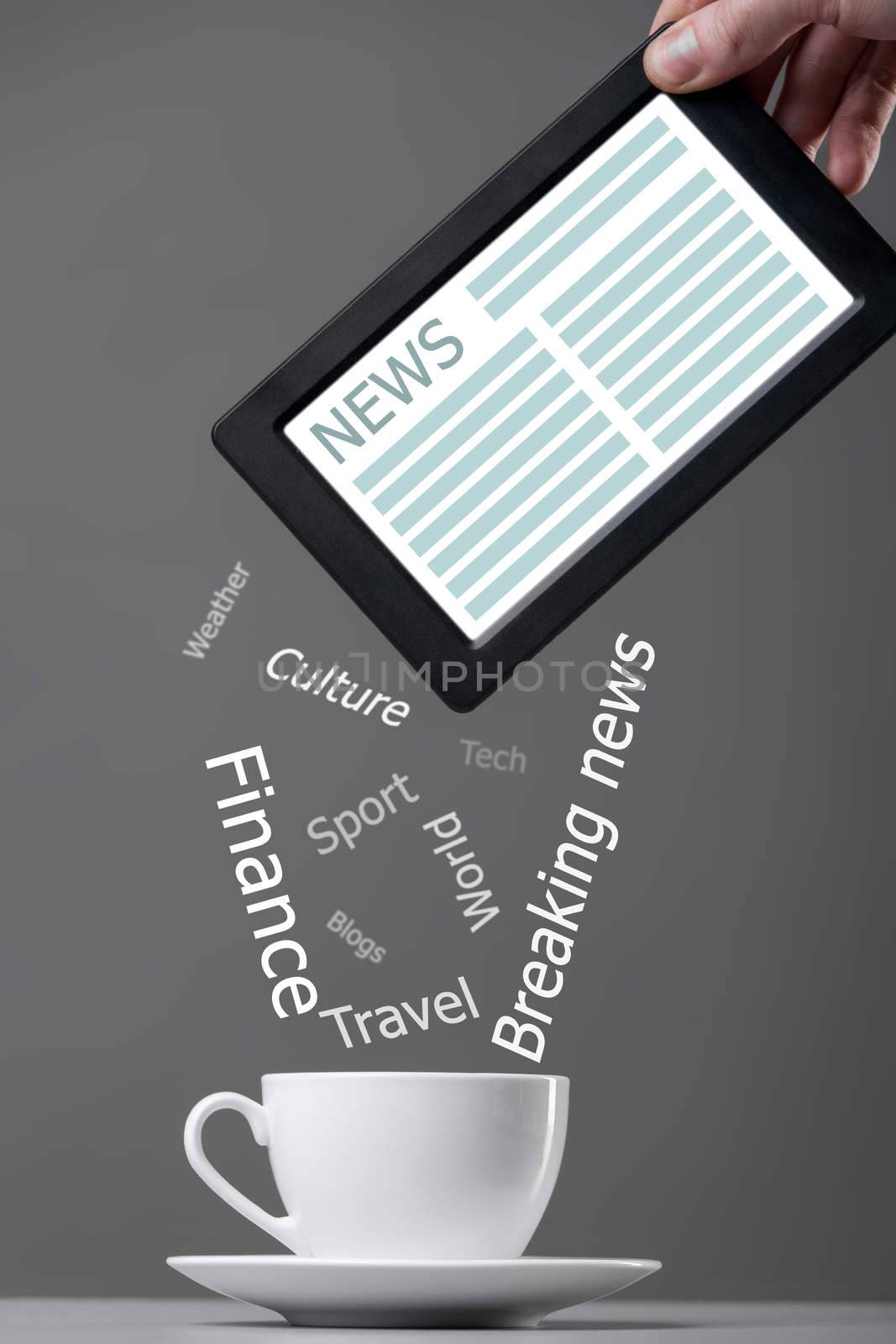 White mug and tablet computer on a gray background. News concept.