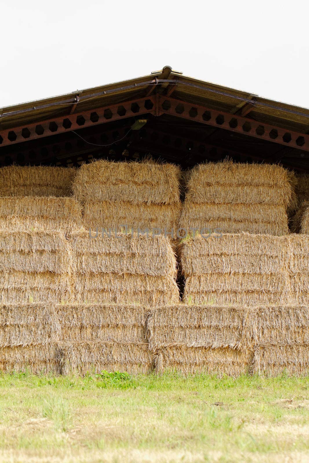 straw bales under the roof in the meadow