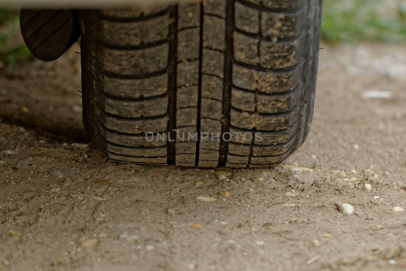 Car wheels on a dusty road detail by NagyDodo