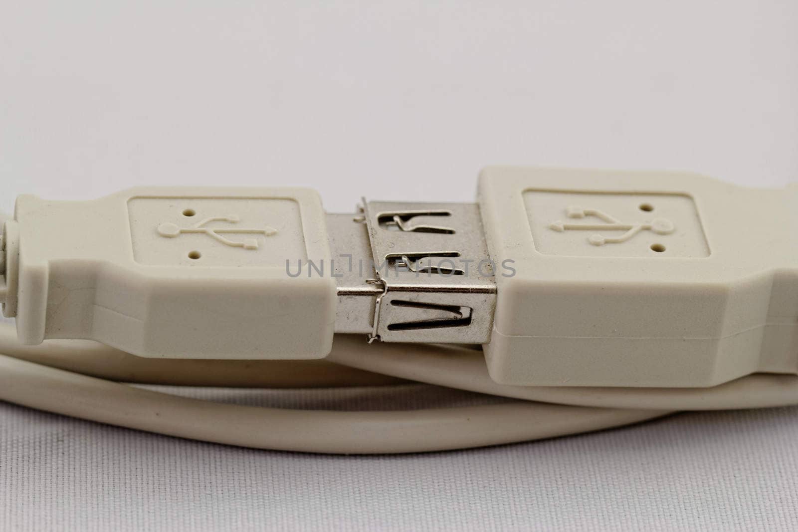 connected white usb extension cable on white background