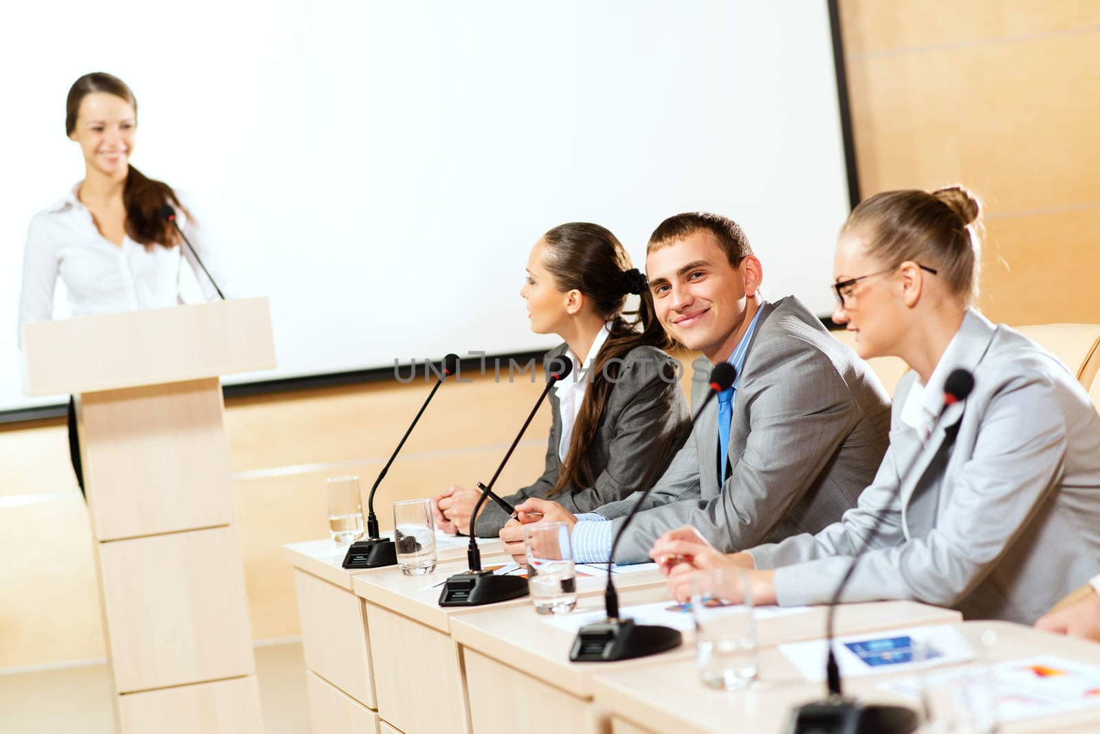 businessmen communicate at the conference, man looking at the camera