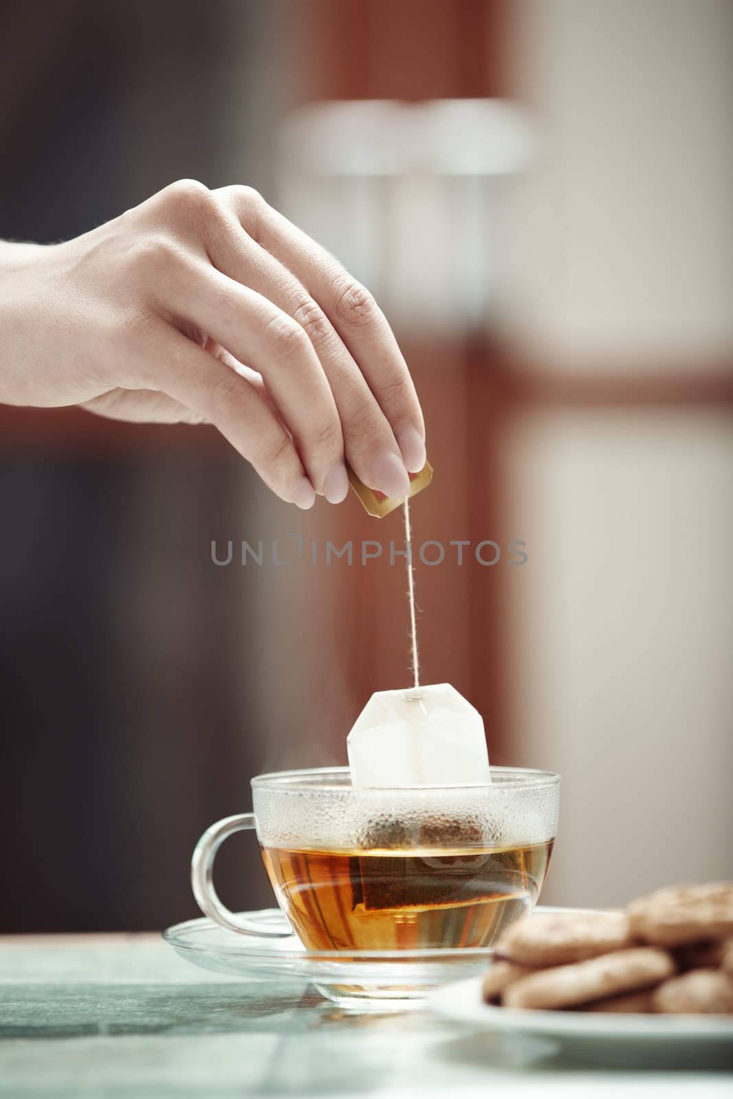 Human hands making tea