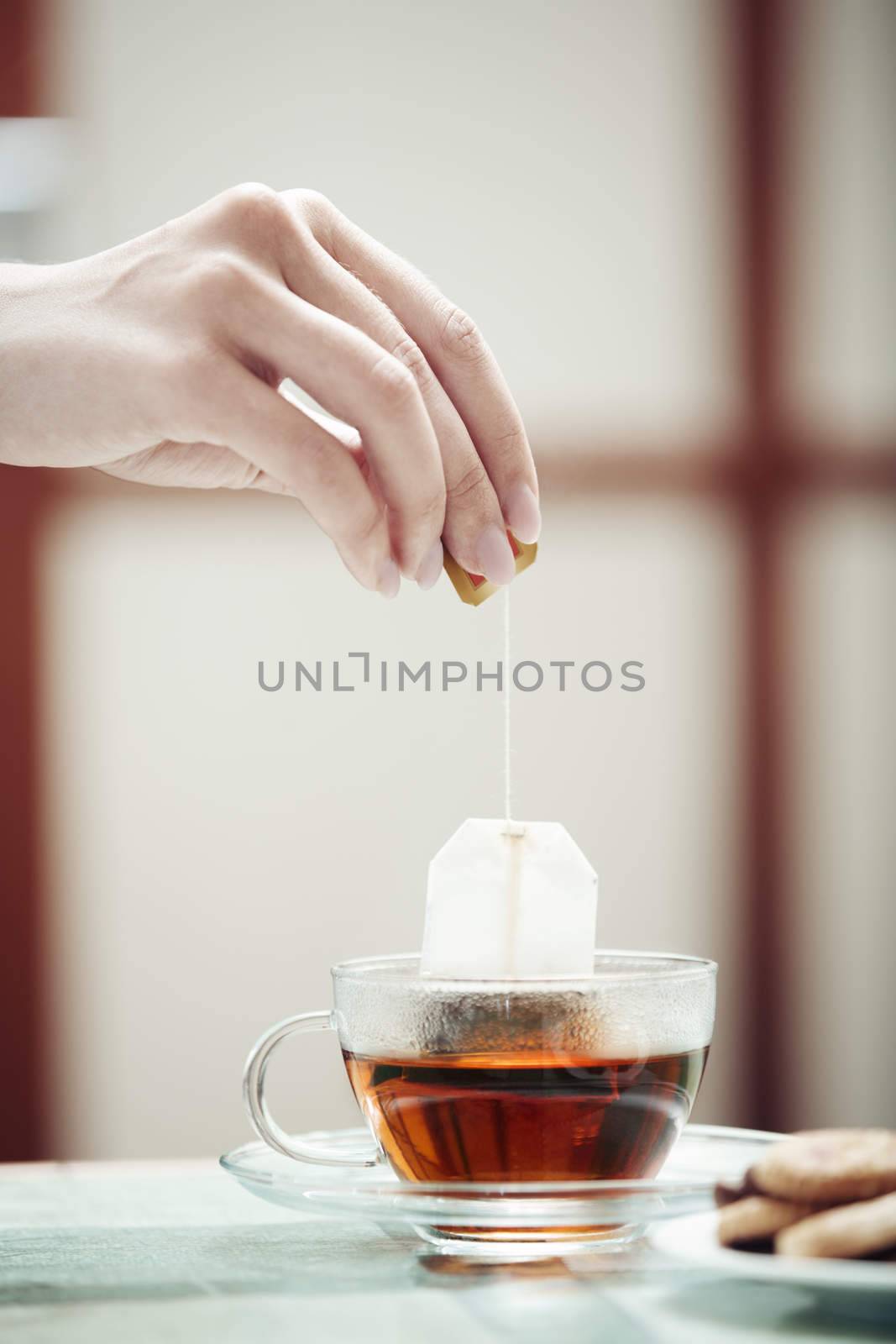 Human hands making tea