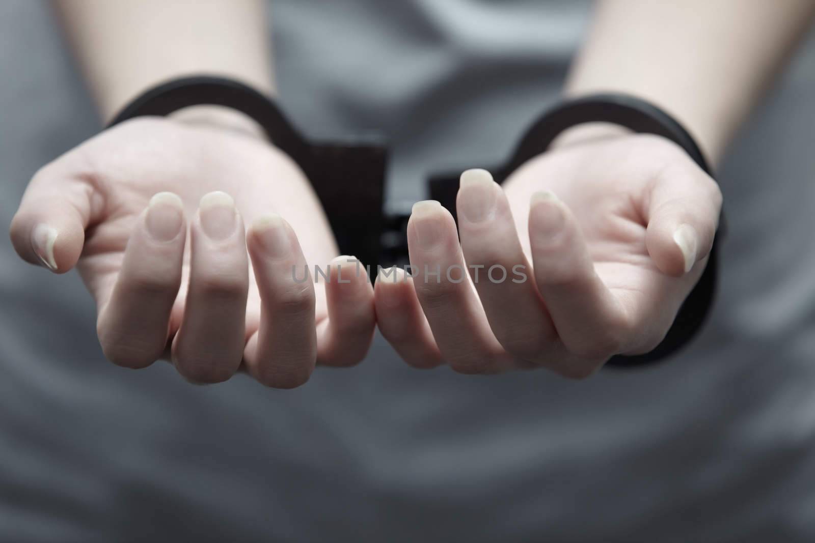 Human hands in handcuffs. Close-up horizontal view