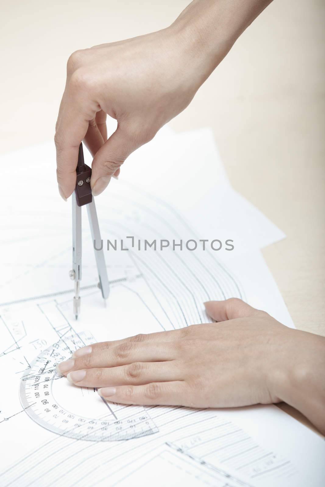 Hands of engineer working on a construction plan