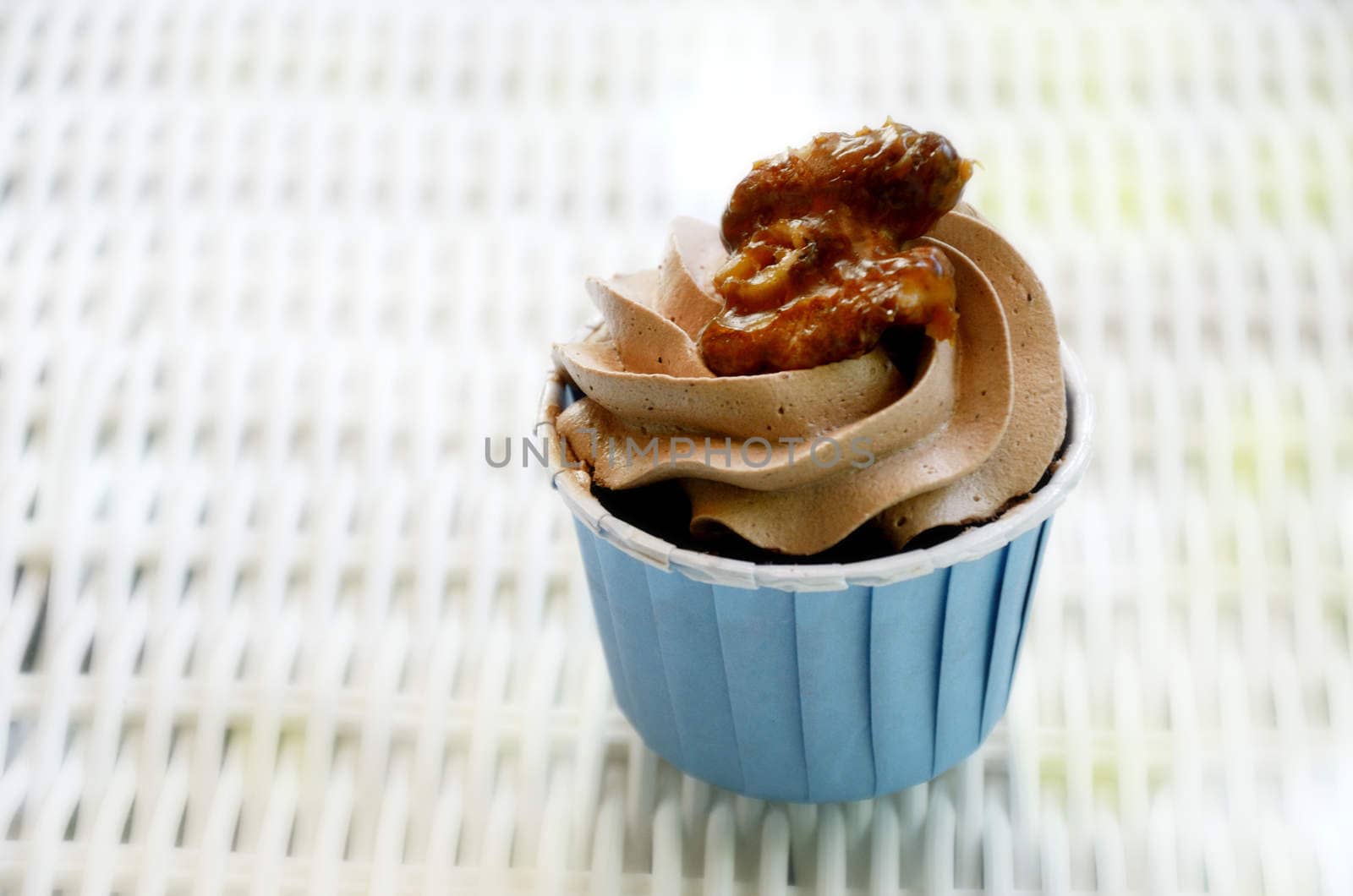 Cupcake with caramel walnut on table