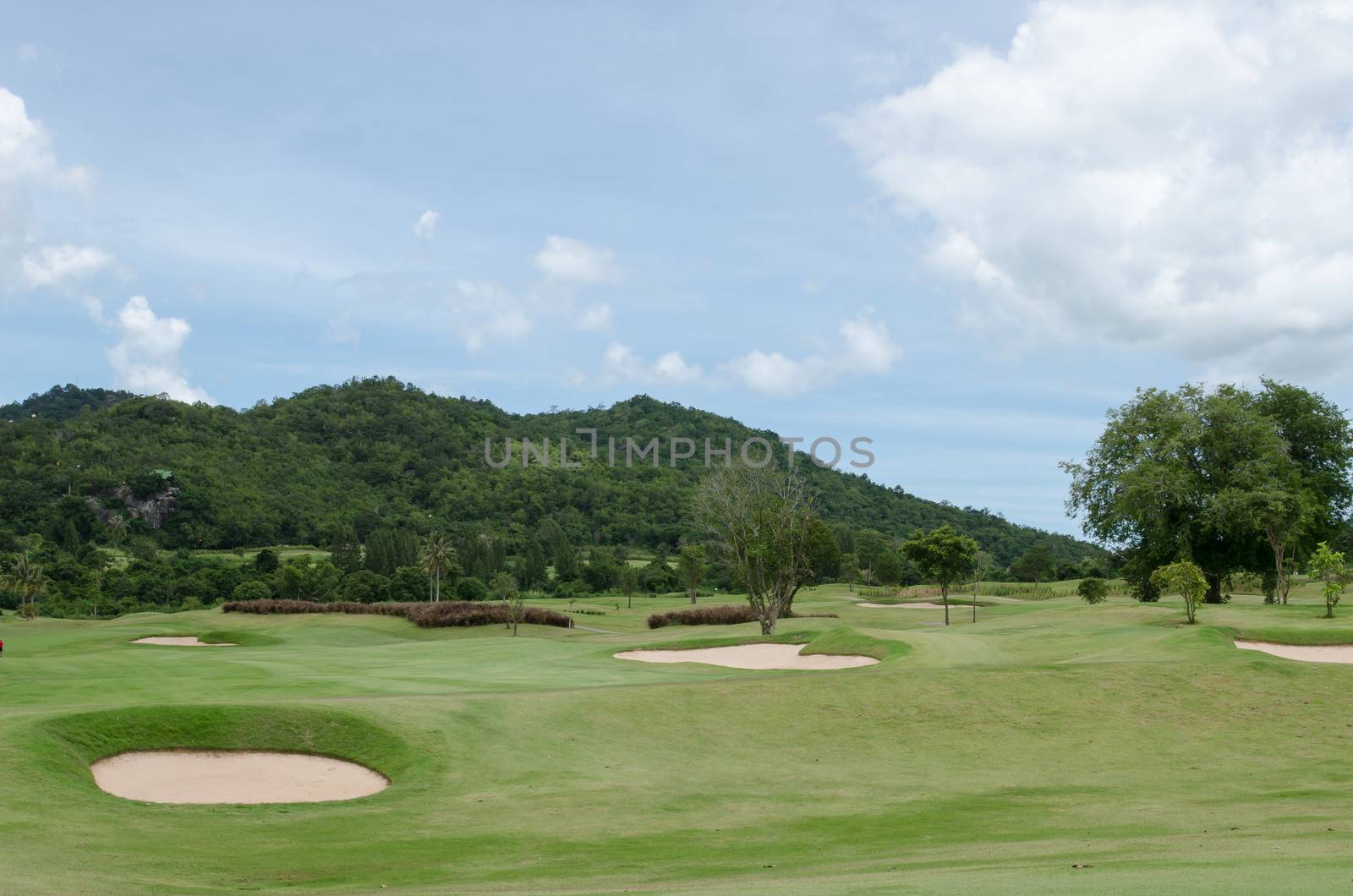 Bunker on golf course under the blue sky