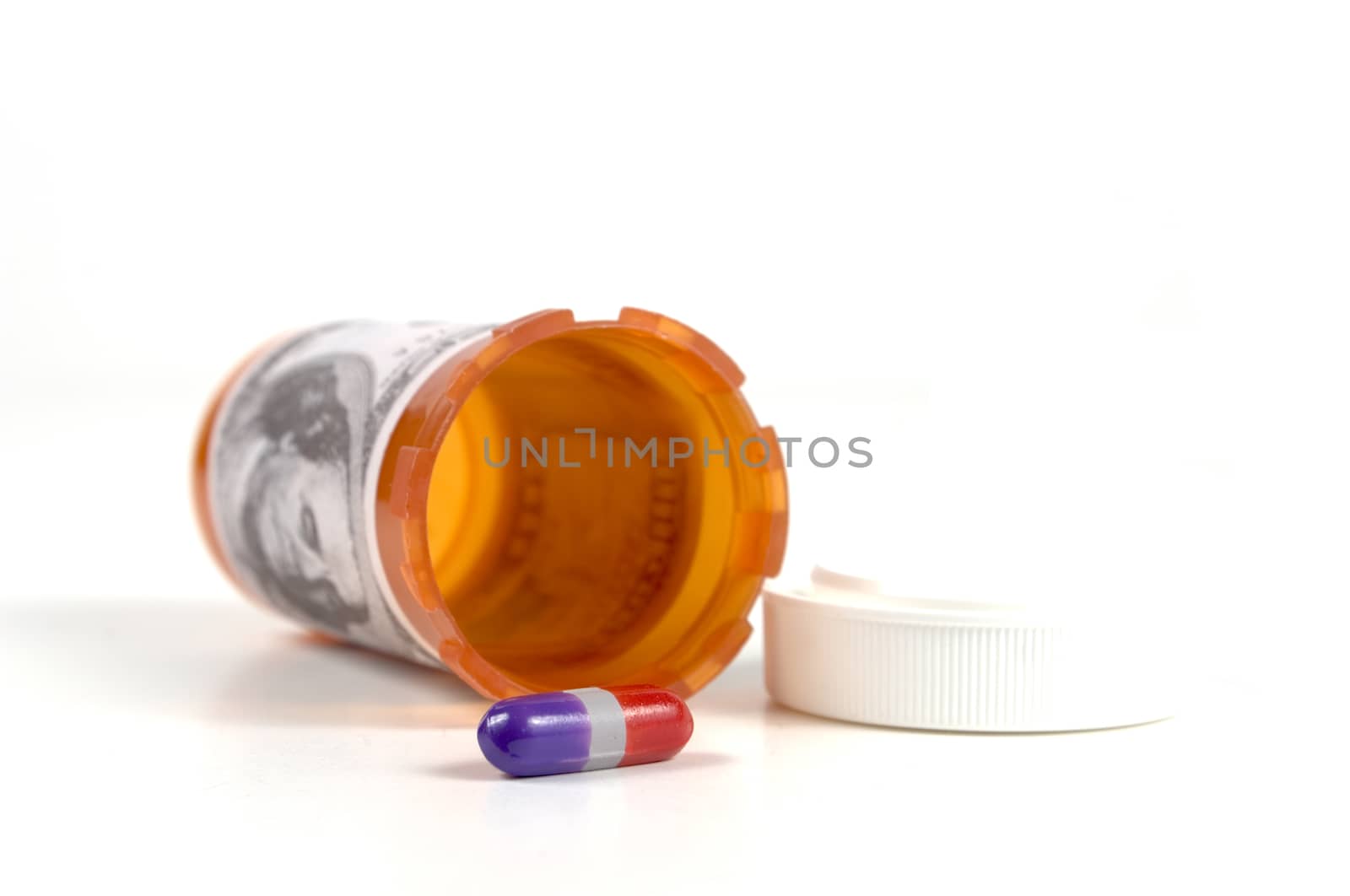 A single purple and red oil with an empty prescription bottle.