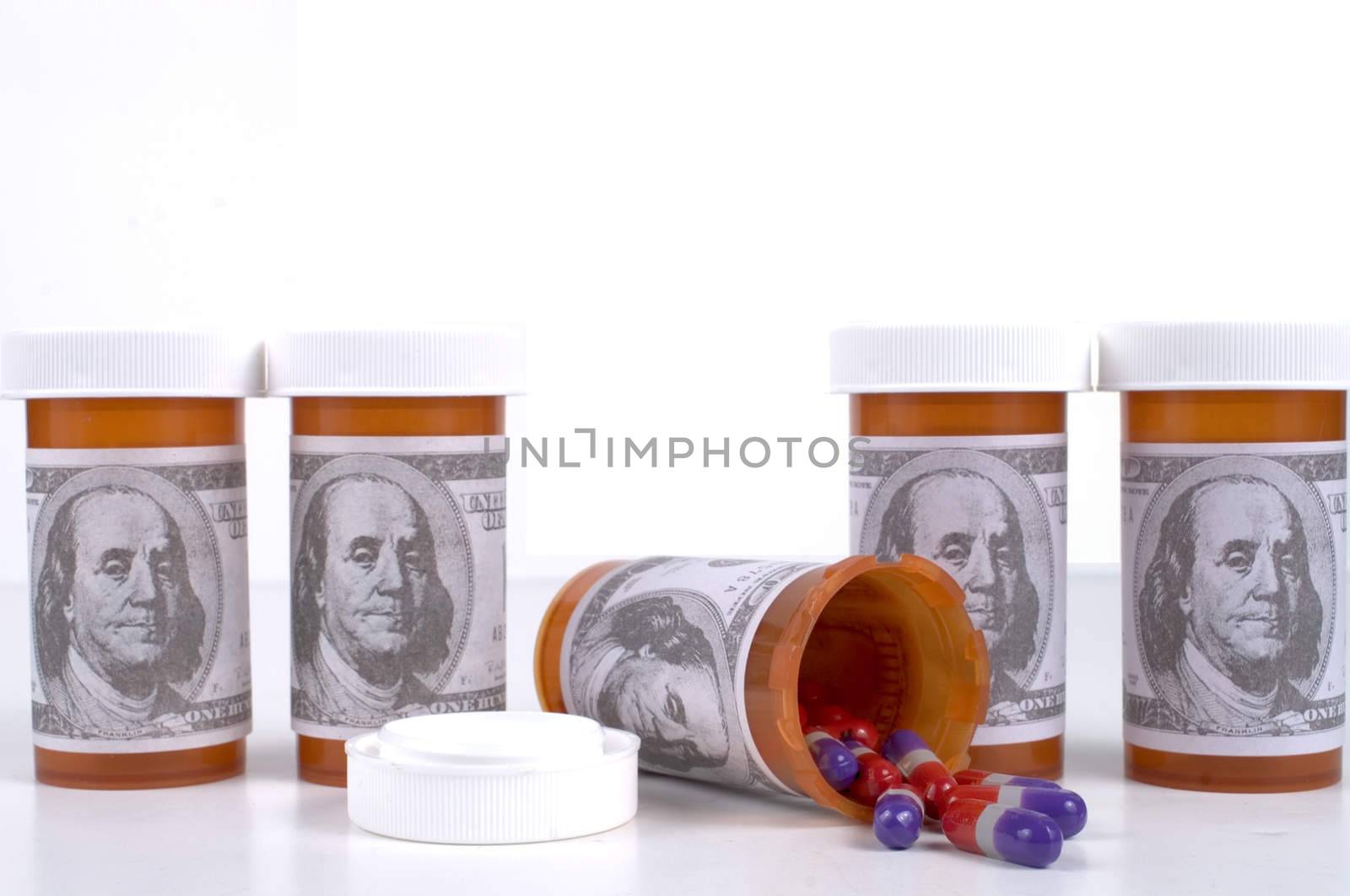 Prescription bottles with dollar bill labels and pills.