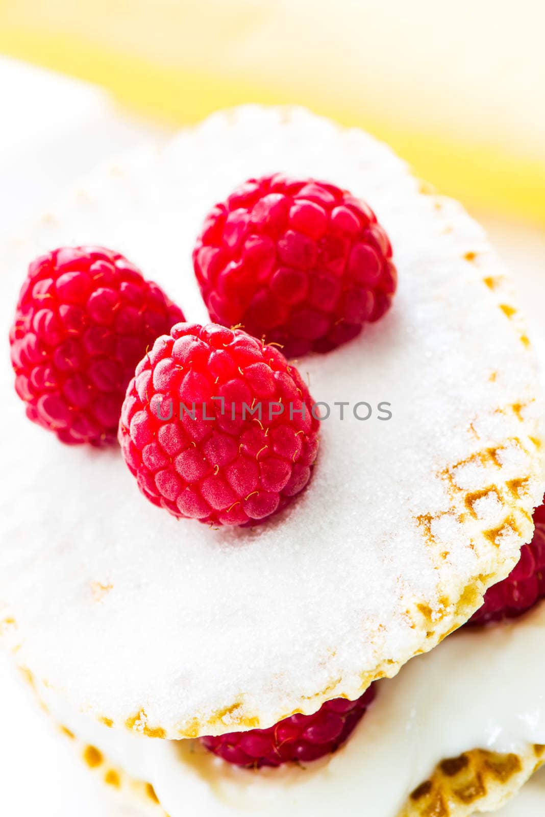 small raspberry cake with cream on white background