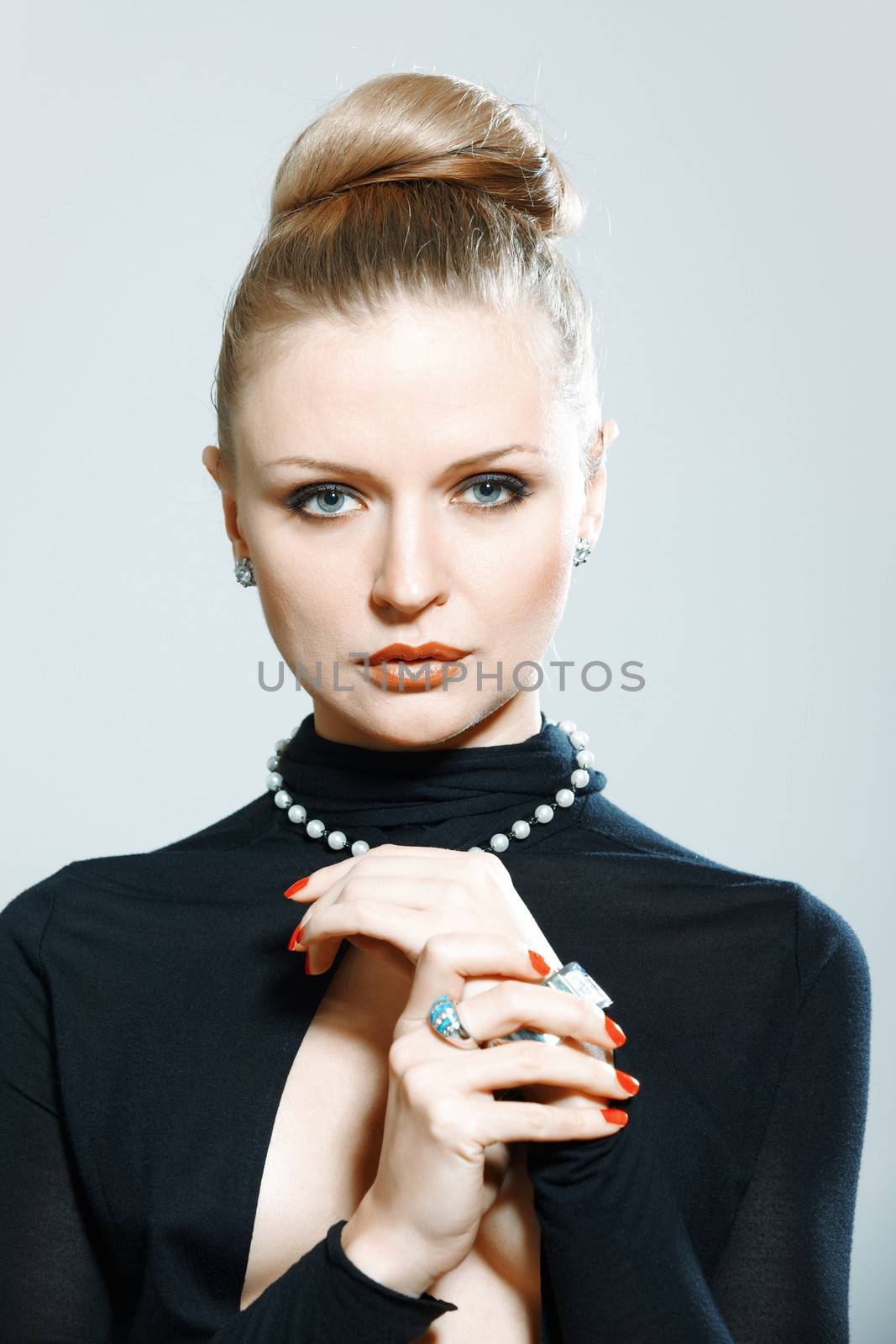 Stylish lady in studio with luxurious jewelry