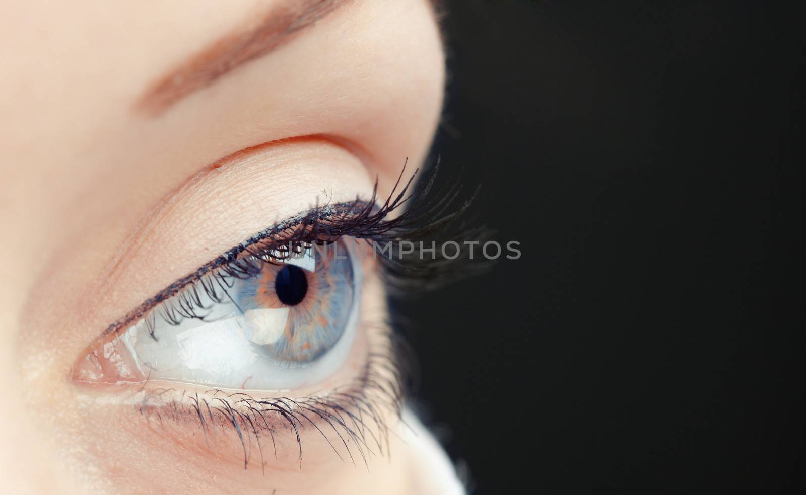 Close-up photo of the human eye on a dark background