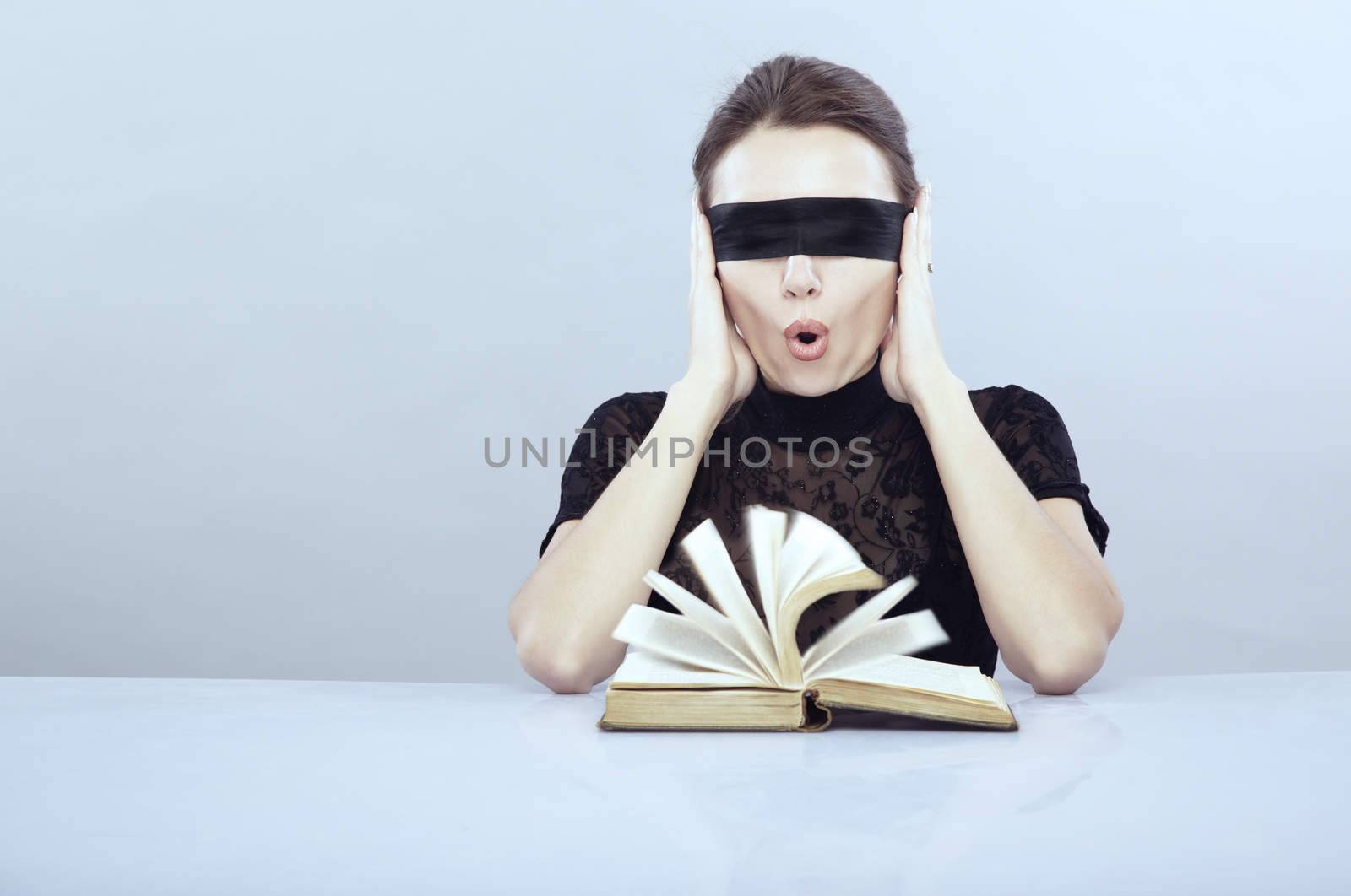 Turned book and screaming lady with closed ears and blindfold