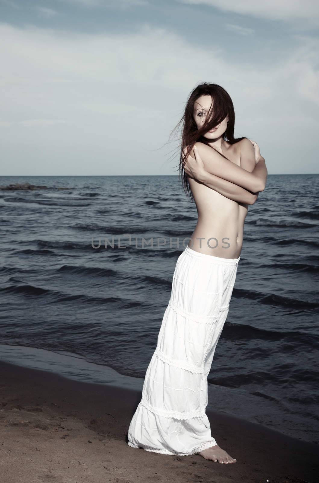 Sensual lady stands at the beach