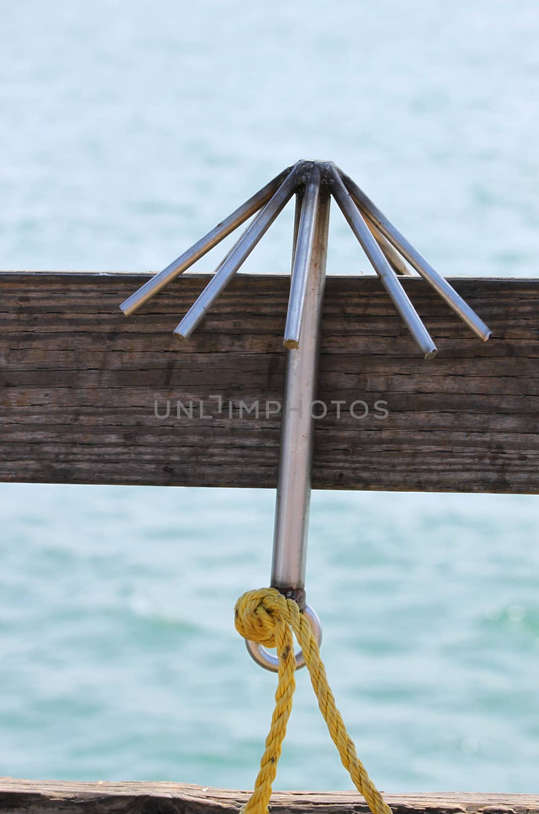 A Hook hanging on a board with the ocean in the background.