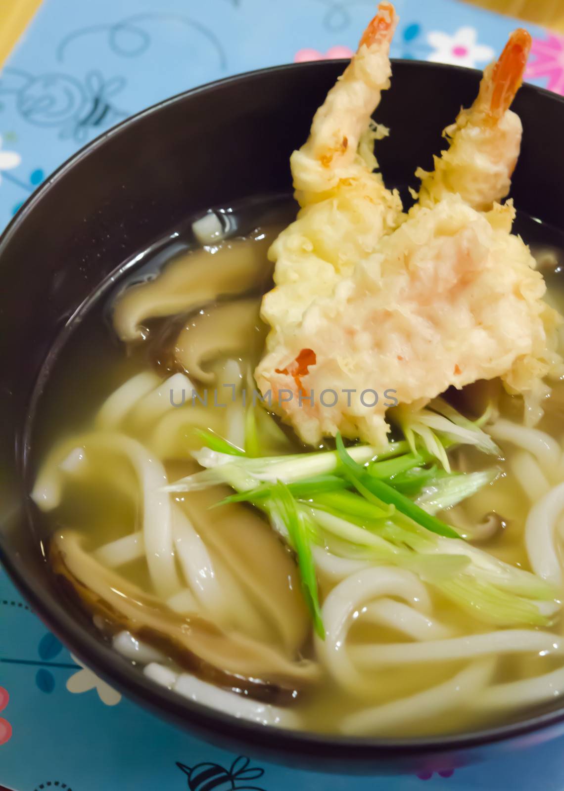top views udon noodles with shrimp tempura in black bowl , Japanese food