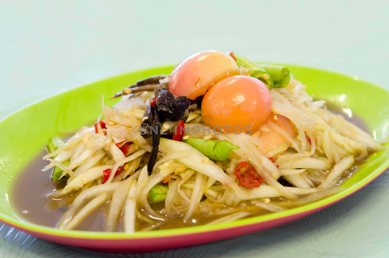 spicy papaya salad with crab and vegetable in green dish