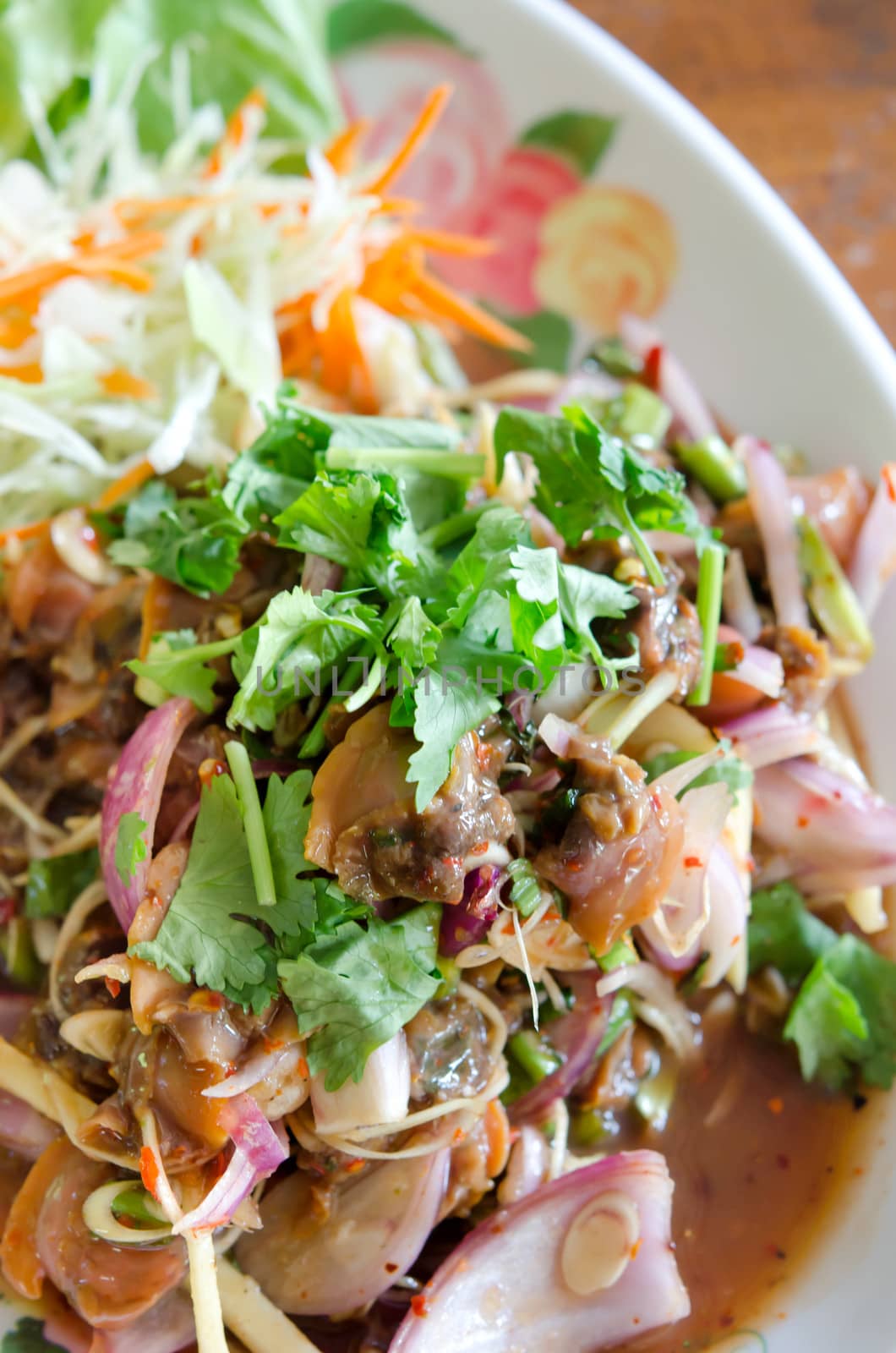 Spicy cockles salad  served with fresh vegetable on dish