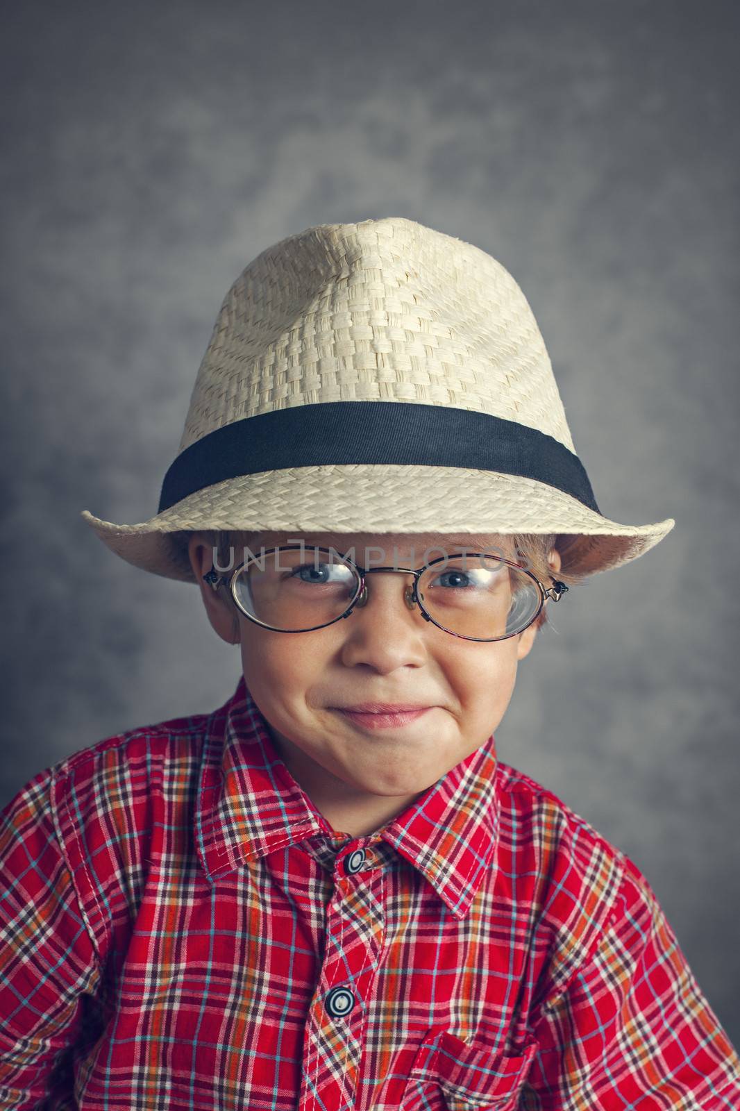 little boy in a cap and glasses