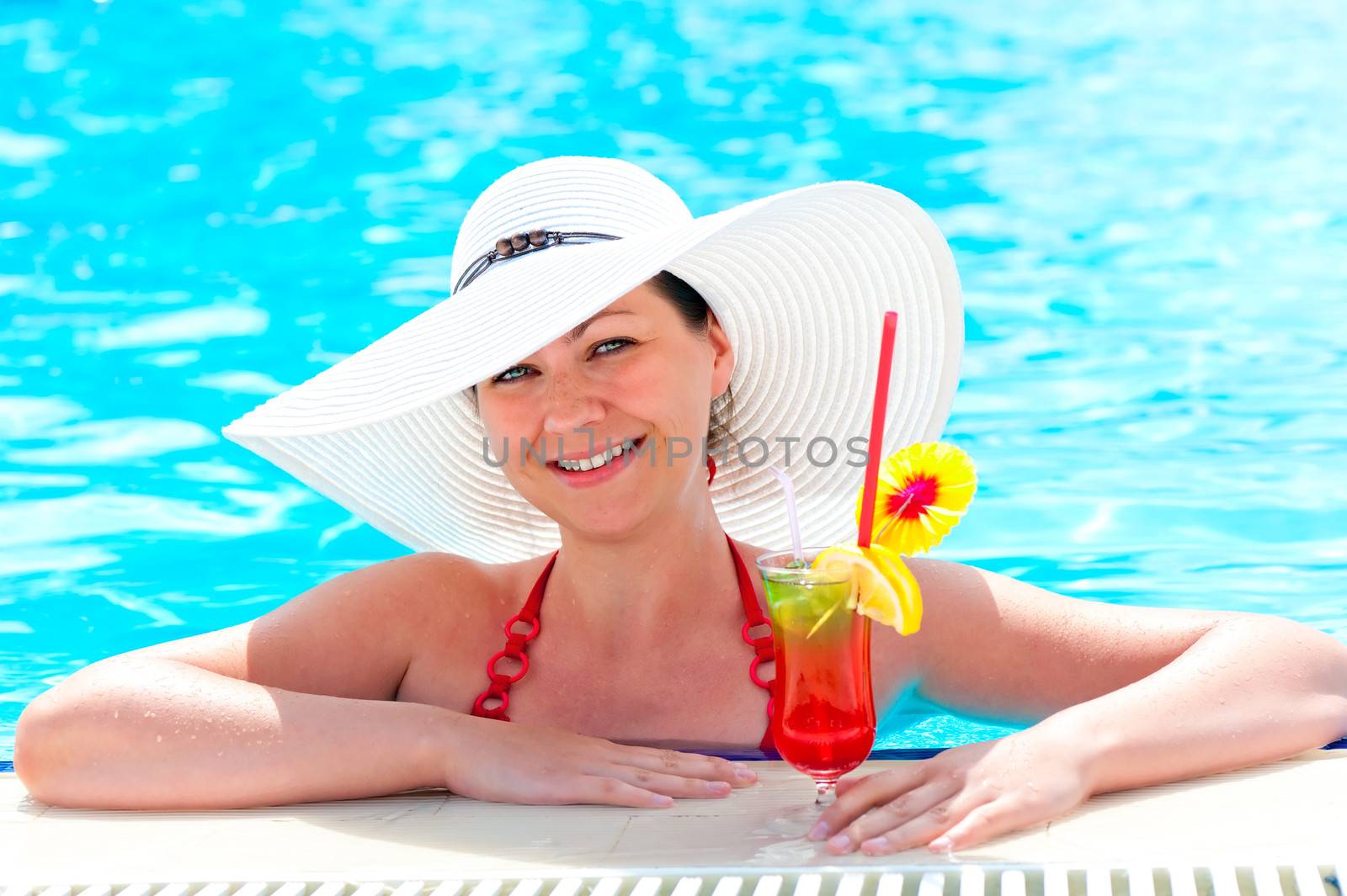 woman in the pool with a cocktail in a white hat by kosmsos111