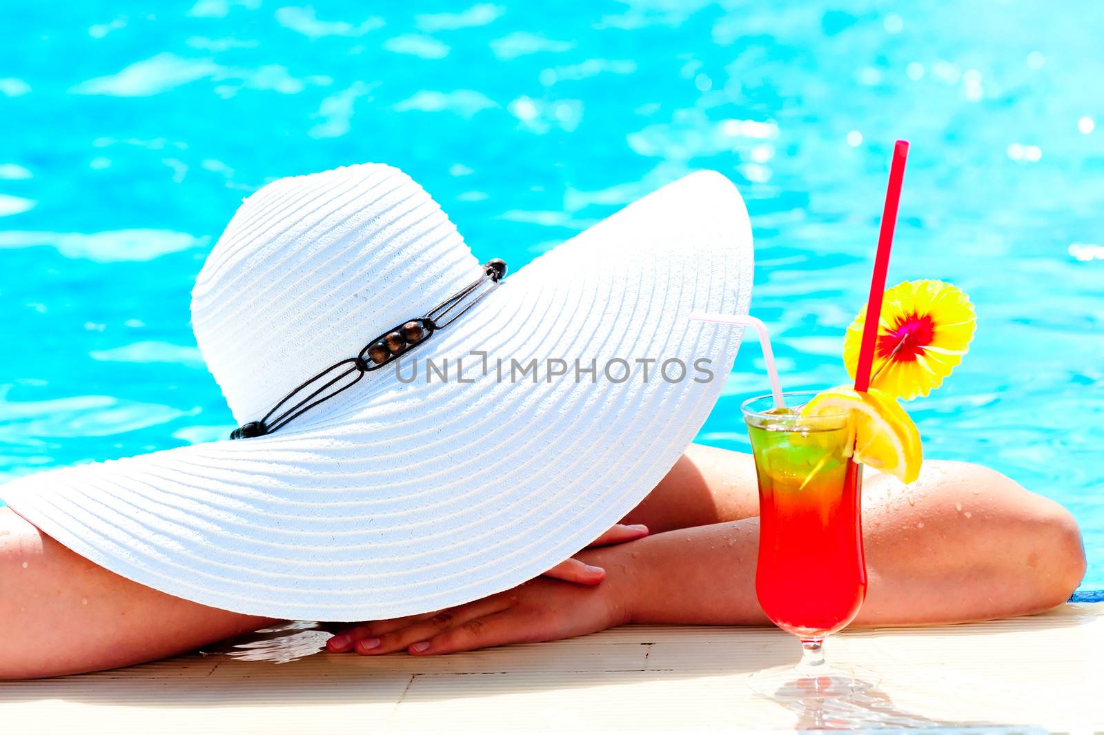 girl in a wide white hat resting in the pool by kosmsos111