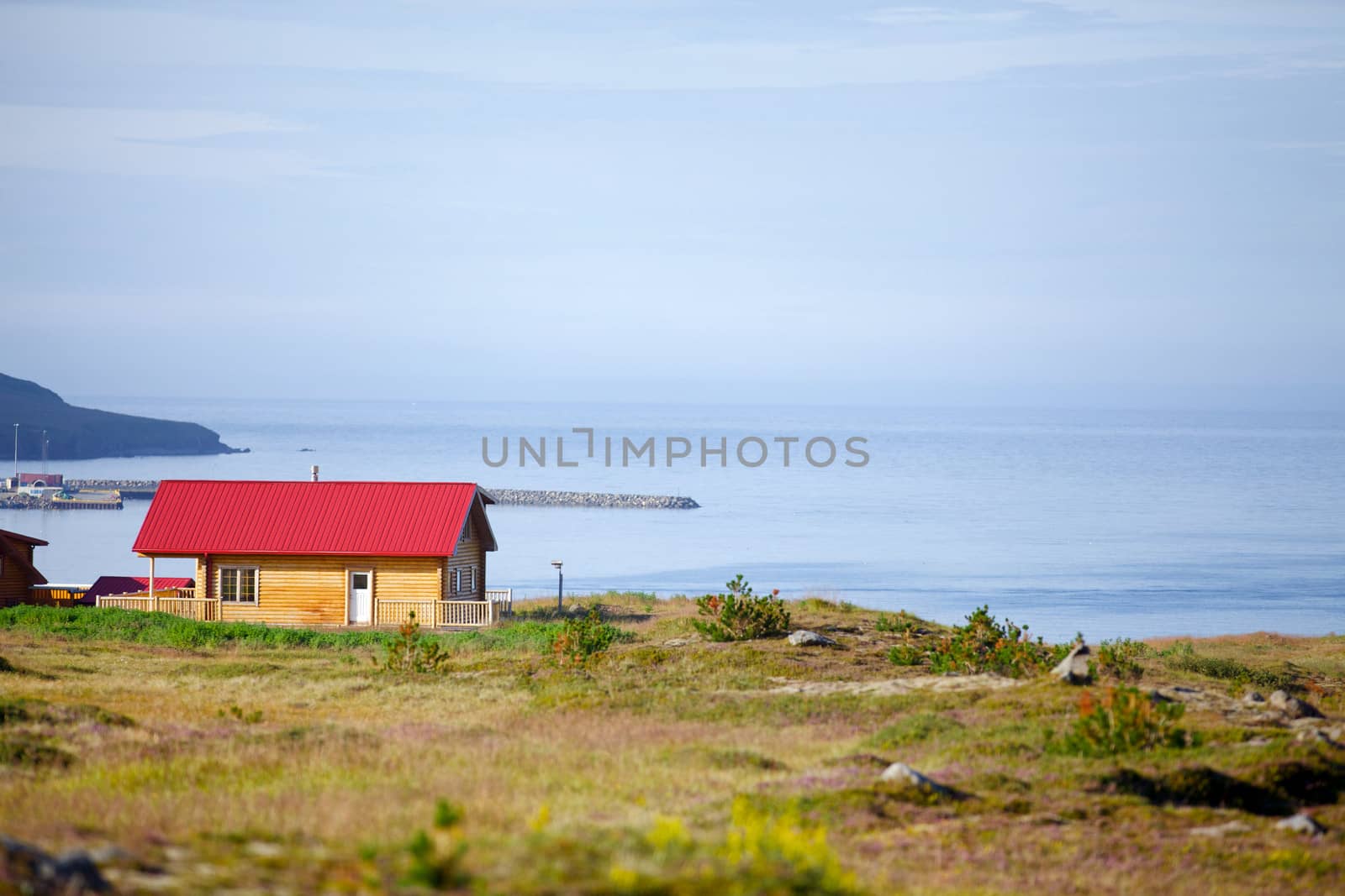 Beautiful house in Iceland. Mountains in background.