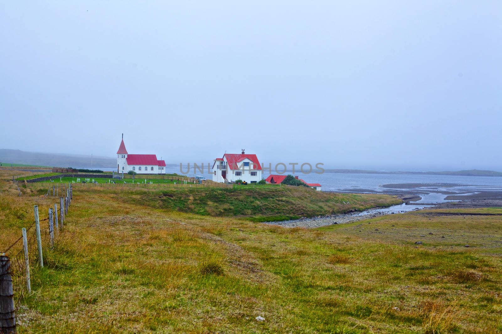 Small white church near the ocean, Iceland. Summer day.