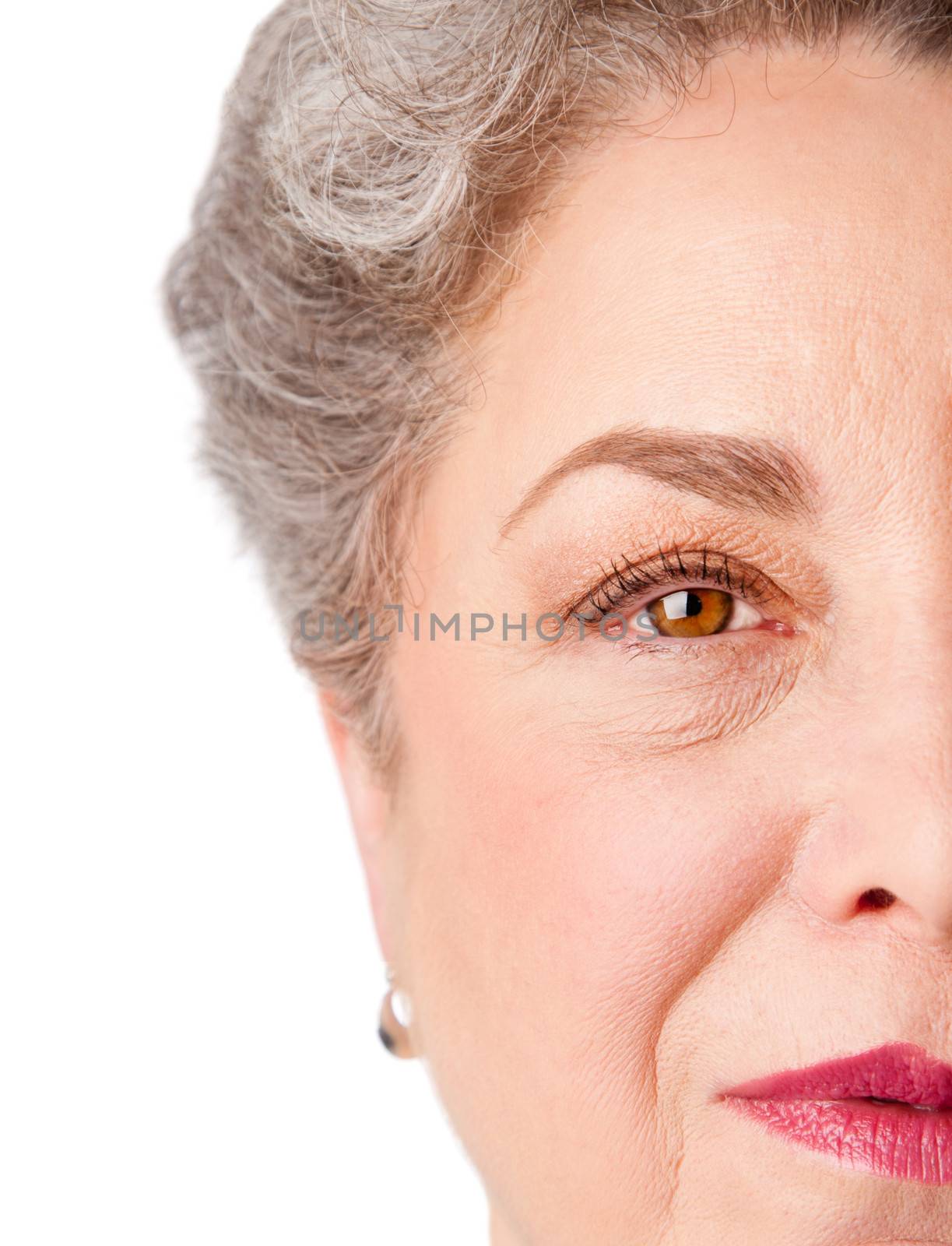 Beautiful watchful eye of a healthy senior woman with experience, isolated.