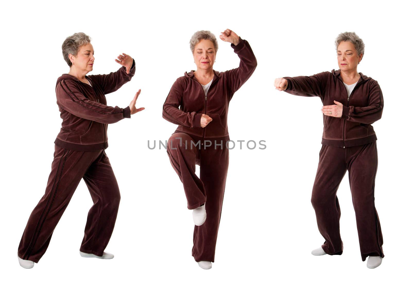 Beautiful Senior woman doing Tai Chi exercise to keep her joints flexible, isolated.