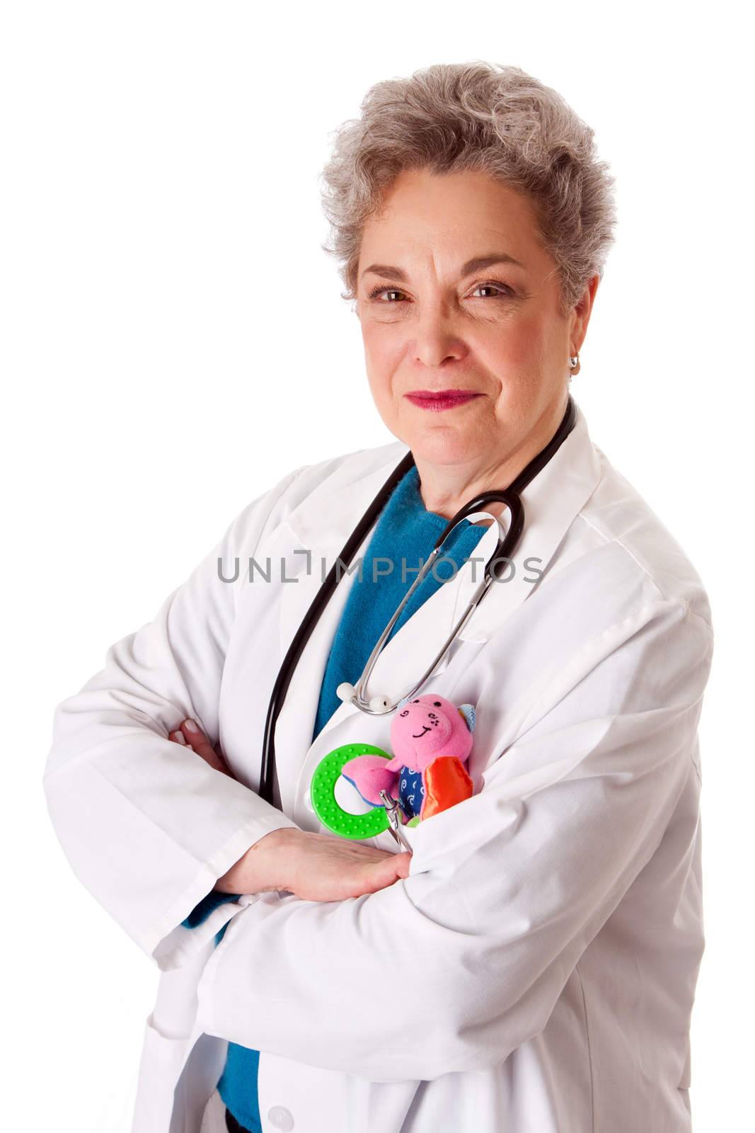 Beautiful happy friendly experienced pediatrician nurse physician standing, isolated. Doctor for children with toy in pocket and stethoscope around neck with arms crossed.