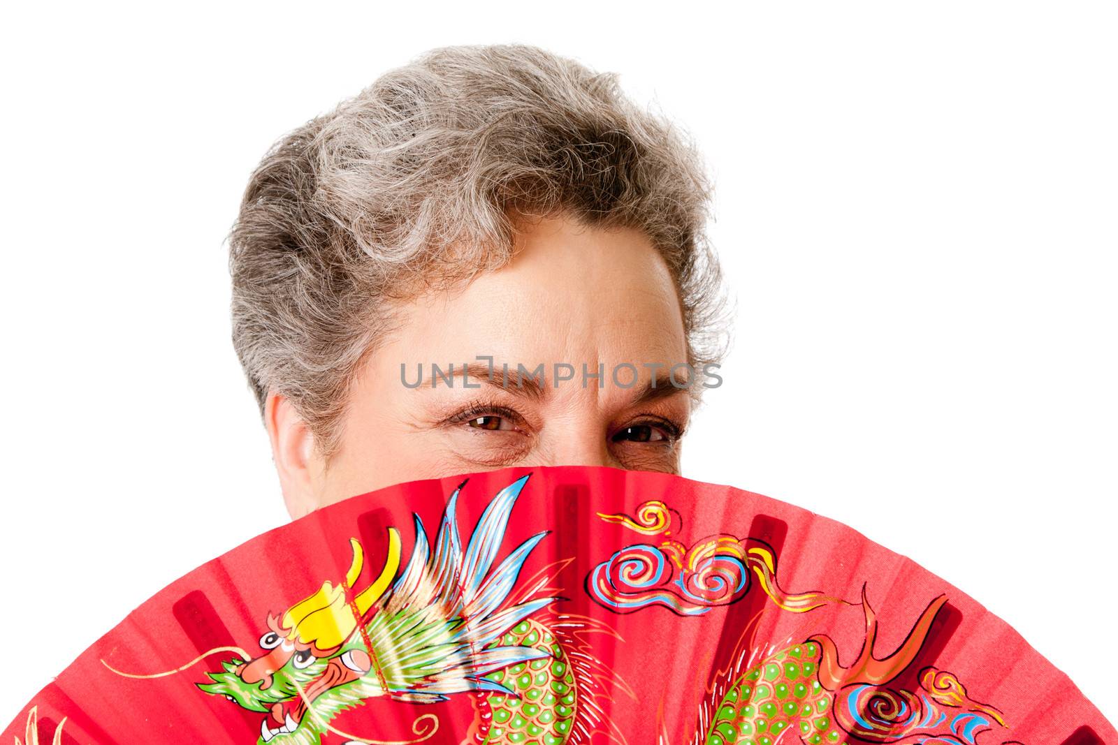 Beautiful Senior woman with gray hair and red Chinese dragon fan, isolated.